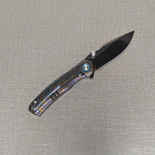 VORIXN Topograph folding knife open with pocket clip side visible, blade angled upward at 45 degrees