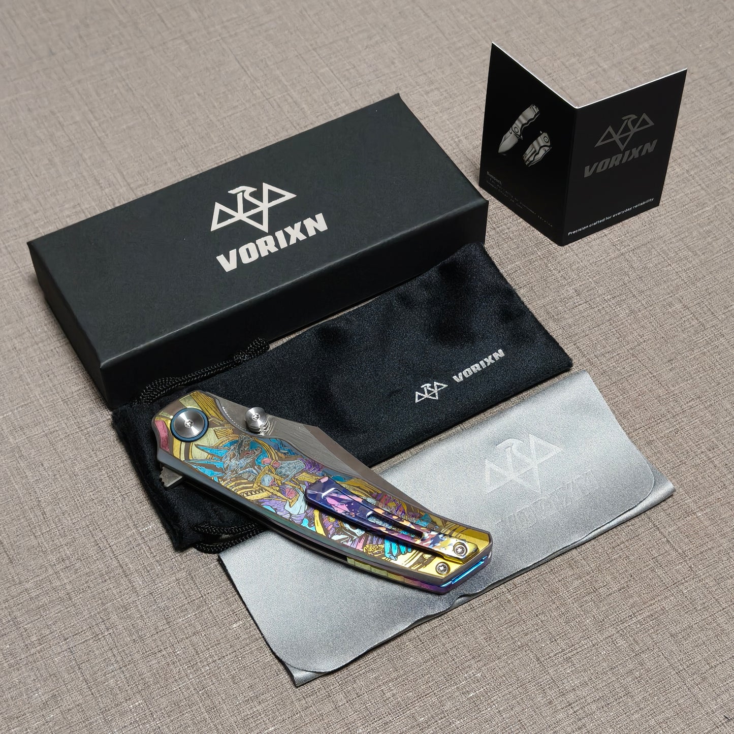 VORIXN folding knife packaging including drawstring pouch, care instruction card, and microfiber cleaning cloth