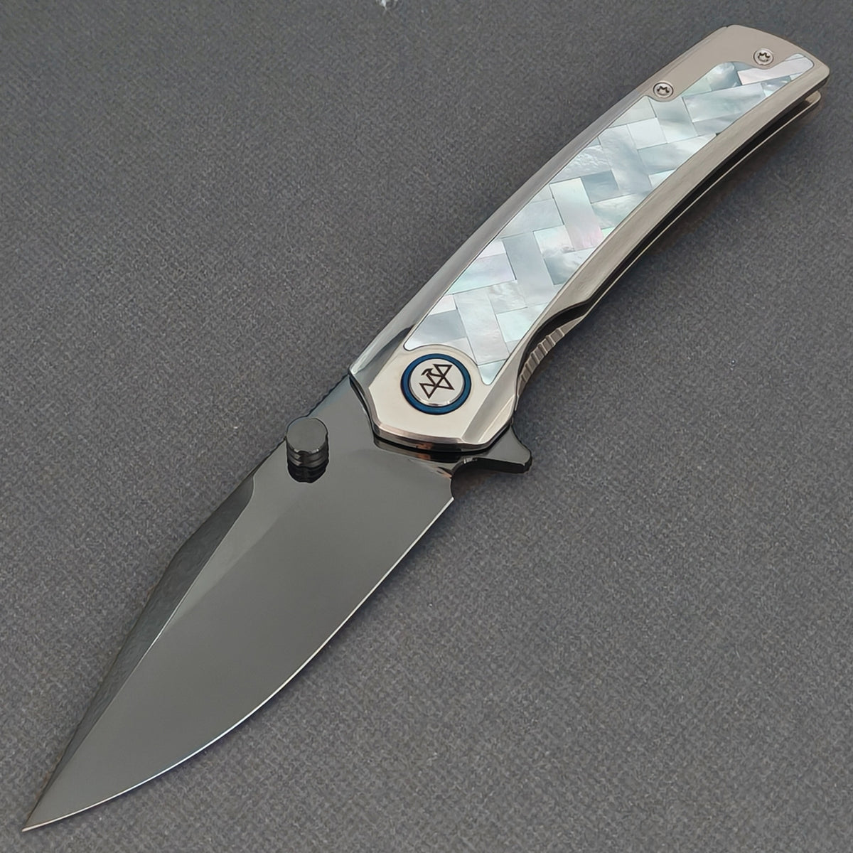 VORIXN Ocean Mirage KB093 folding knife, open view showing a dark blade and white basketweave-pattern handle inlay.