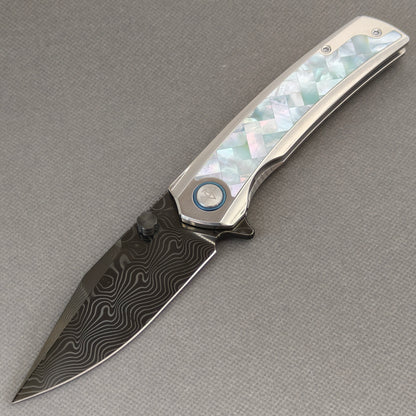 VORIXN Ocean Mirage KB104 Folding Knife – open non-clip side view showing White Mother-of-Pearl Inlaid Titanium handle and Damascus DLC-Coated blade profile