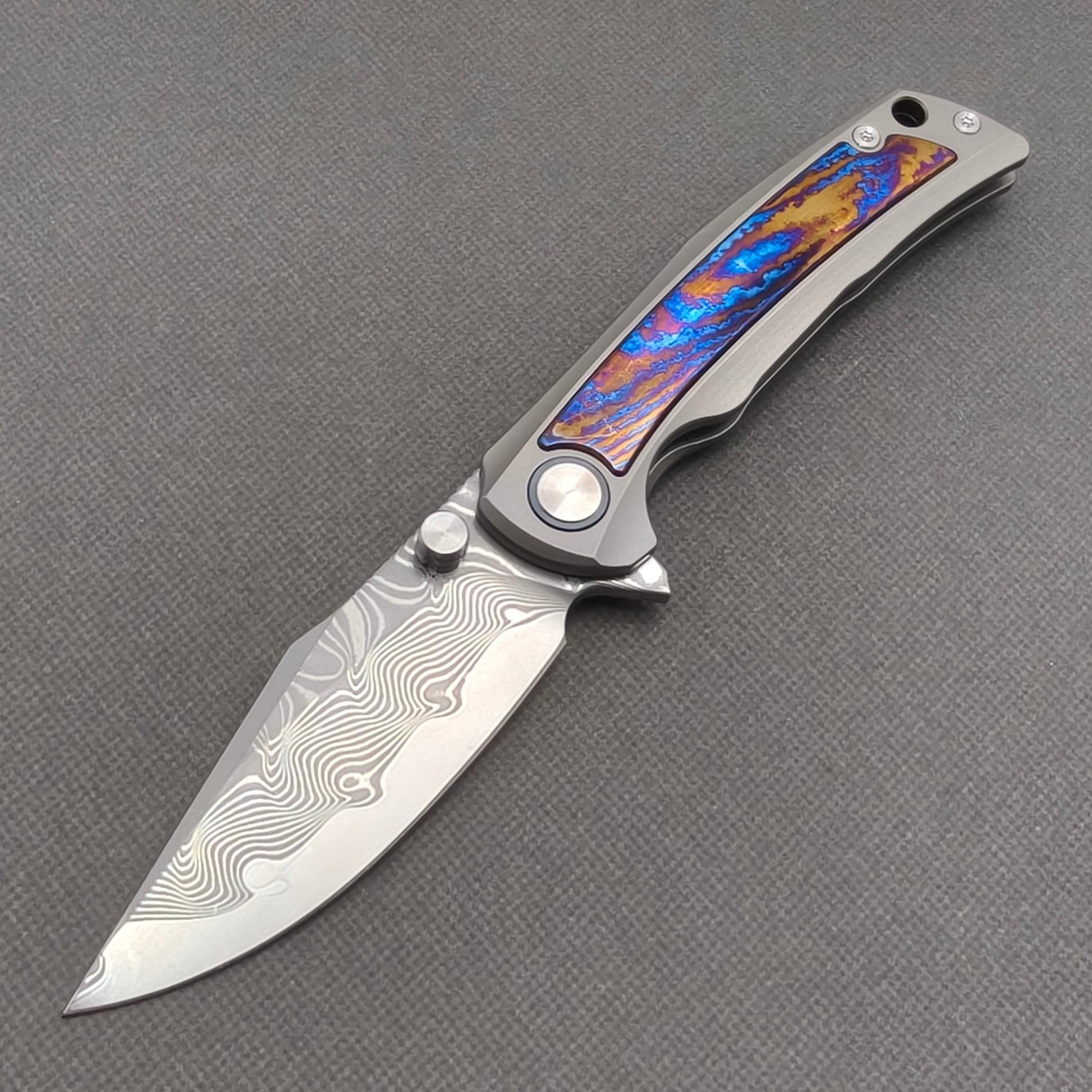 VORIXN KB019 Nebula Damascus folding knife open non-clip side view with titanium and zirconium inlay handle and overall profile.