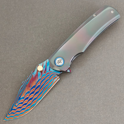 VORIXN Steelwraith KB143 Folding Knife – open non-clip side view showing Zirconium handle and Damascus blade profile.