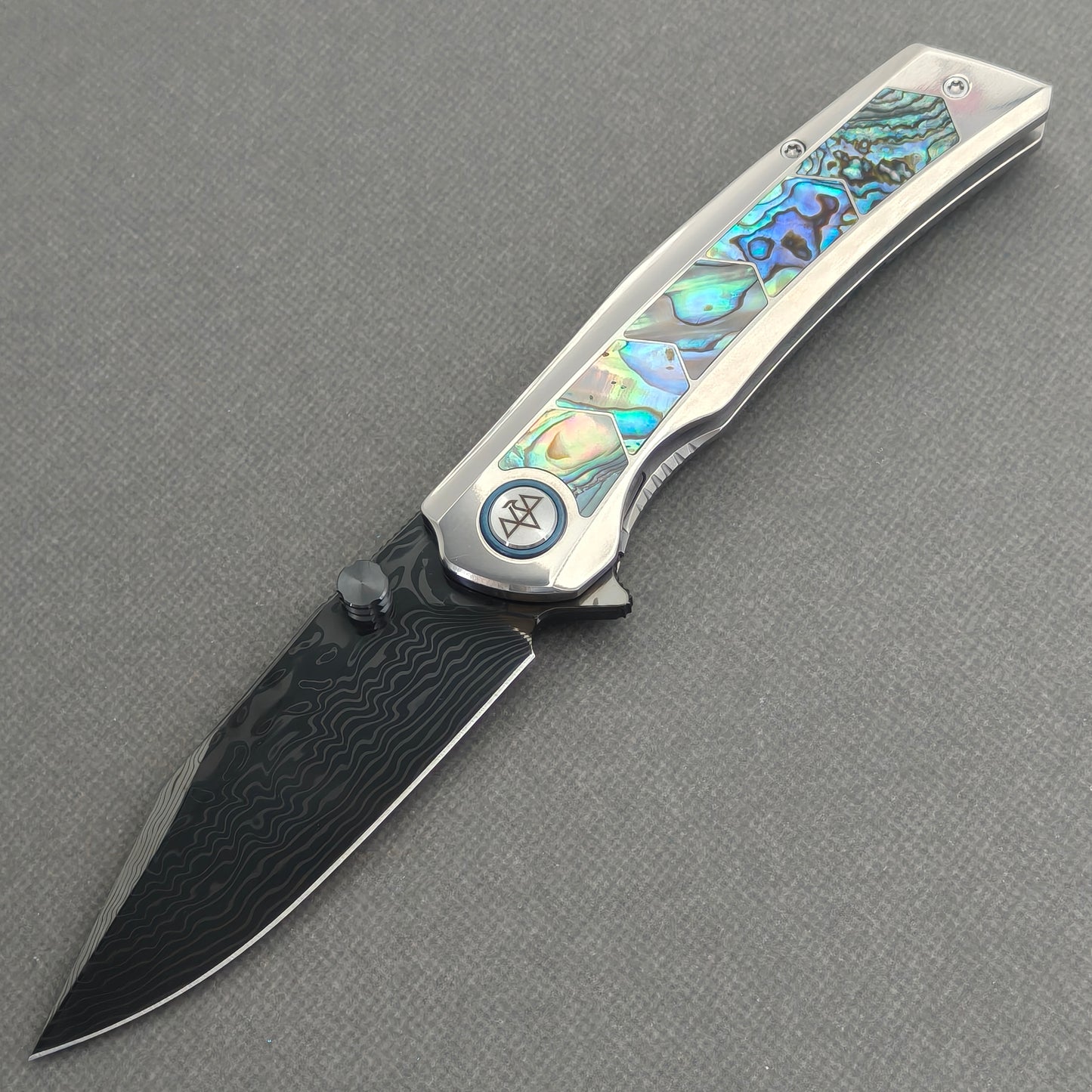 VORIXN Ocean Mirage KB130 Folding Knife – open non-clip side view showing deep-sea abalone shell inlay titanium handle and Damascus blade profile