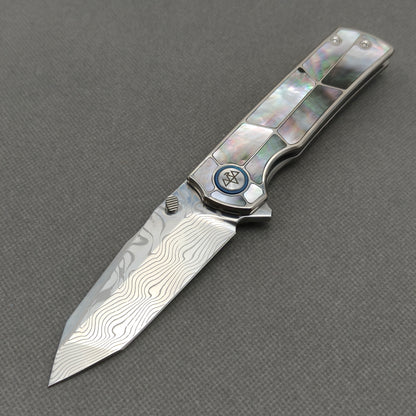 VORIXN KB059 Ocean Mirage Damascus folding knife open non-clip side view with black mother-of-pearl inlaid titanium handle and overall profile.