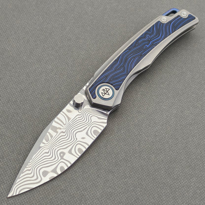 VORIXN Tidecipher KB157 Folding Knife – open non-clip side view showing Damascus blade and blue wave-pattern handle inlay.