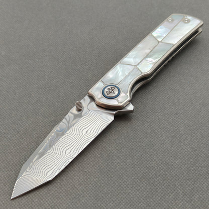 VORIXN KB063 Ocean Mirage Damascus folding knife open non-clip side view with white mother-of-pearl inlaid titanium handle and overall profile.