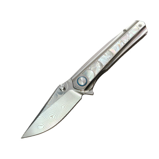 VORIXN Ocean Mirage folding knife open non-clip side, Damascus blade angled 45 degrees downward, titanium handle inlay detail