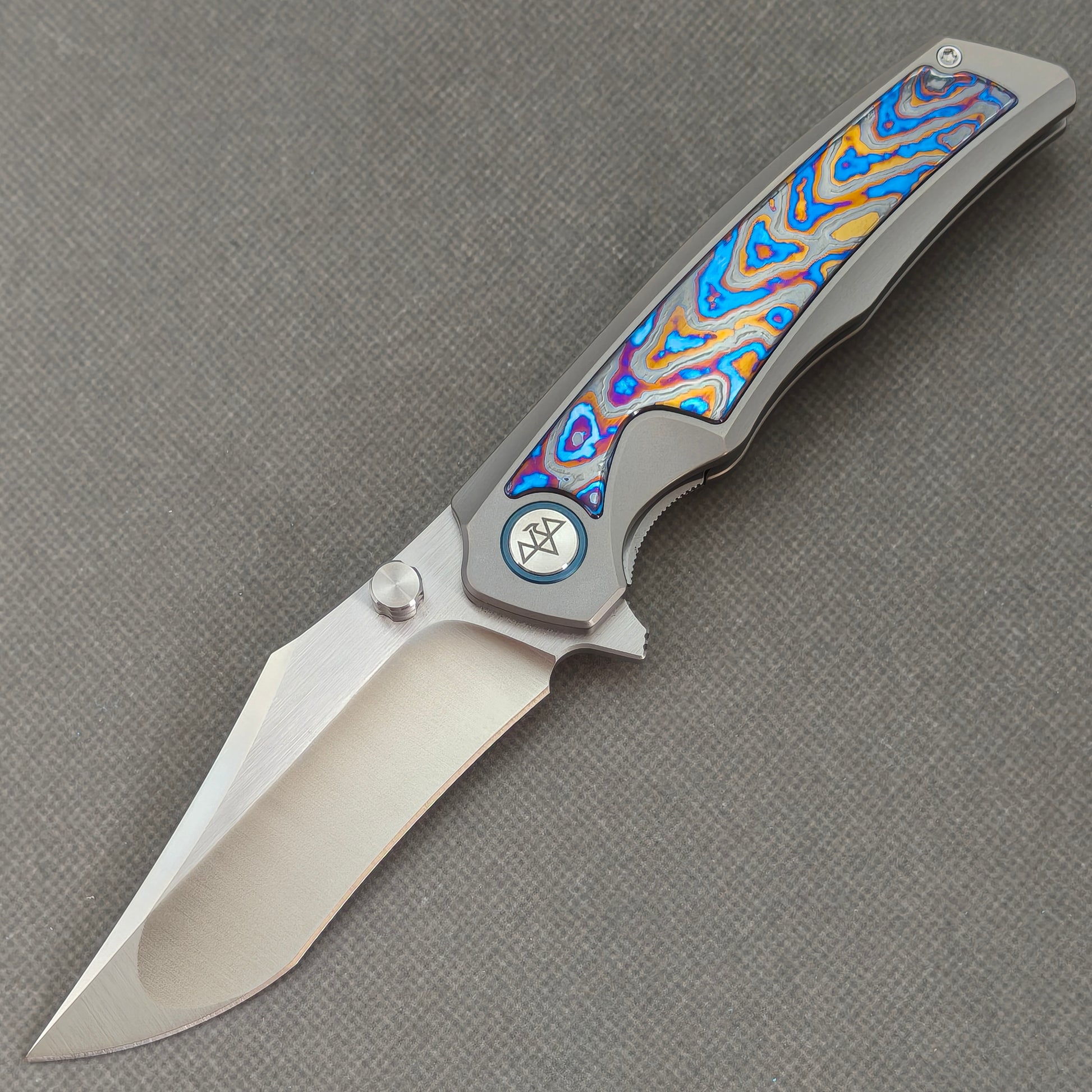 VORIXN KB030 Abyssal Folding Knife – open non-clip side view showing Titanium and Hand-flamed Zirconium handle with 10Cr15CoMoV blade