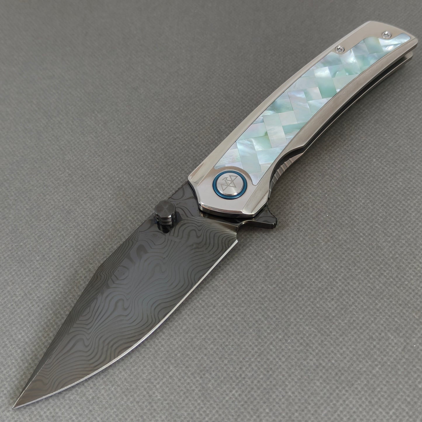 VORIXN KB104 Ocean Mirage Folding Knife – open non-clip side view showing White Mother-of-Pearl Inlaid Titanium handle and DLC-coated Damascus blade profile