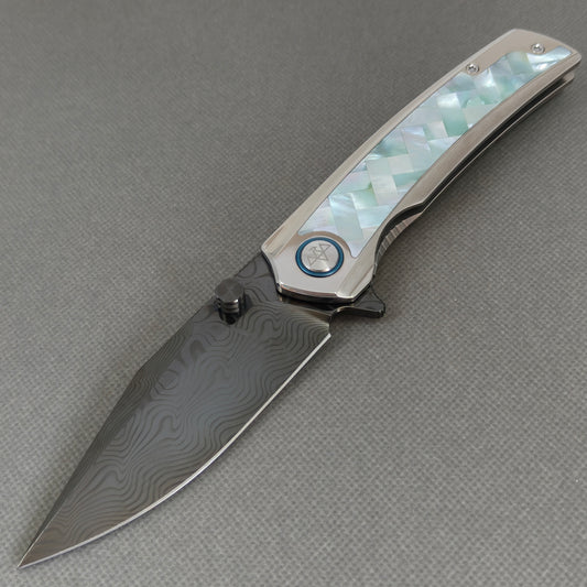VORIXN KB104 Ocean Mirage Folding Knife – open non-clip side view showing White Mother-of-Pearl Inlaid Titanium handle and DLC-coated Damascus blade profile