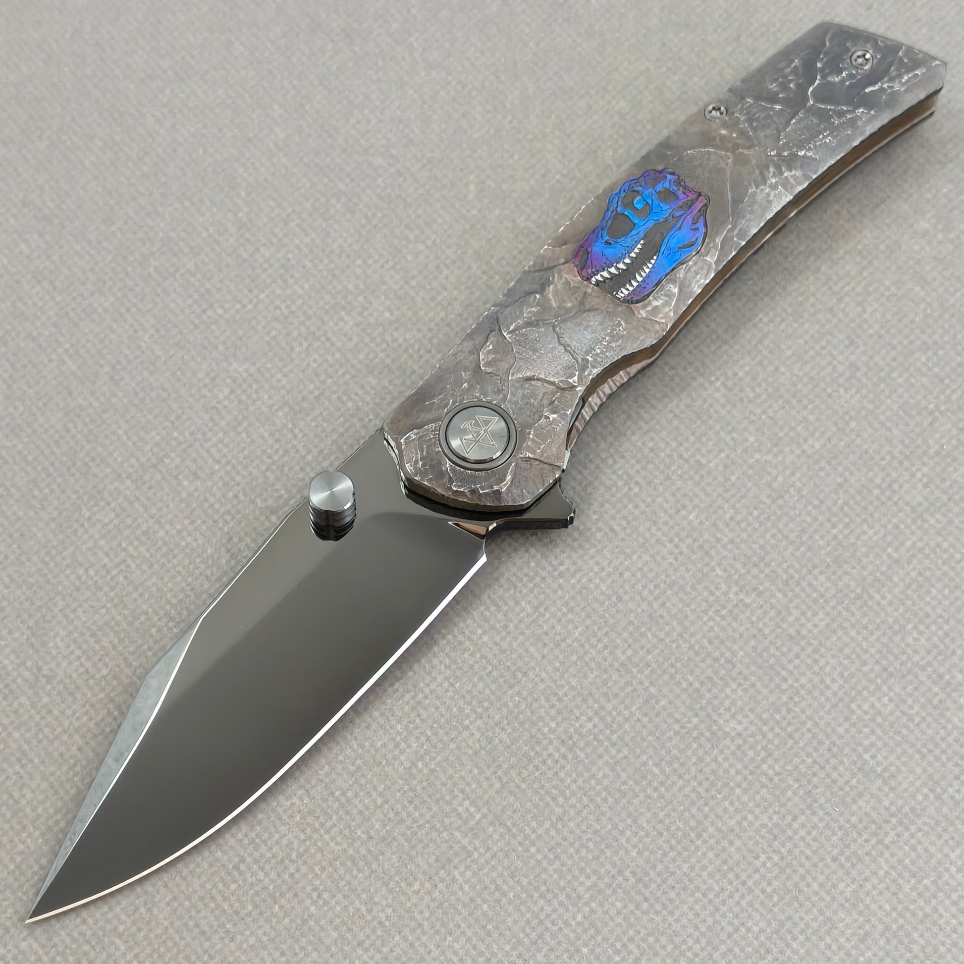 VORIXN Rex KB118 Folding Knife – open non-clip side view showing hand-engraved anodized titanium handle and M390 blade profile