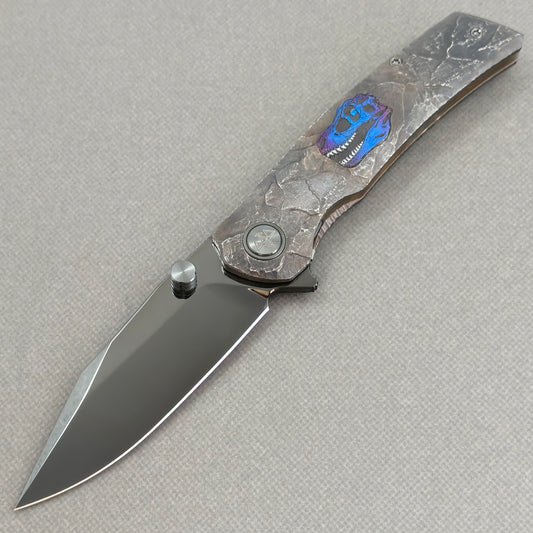 VORIXN Rex KB118 Folding Knife – open non-clip side view showing hand-engraved anodized titanium handle and M390 blade profile