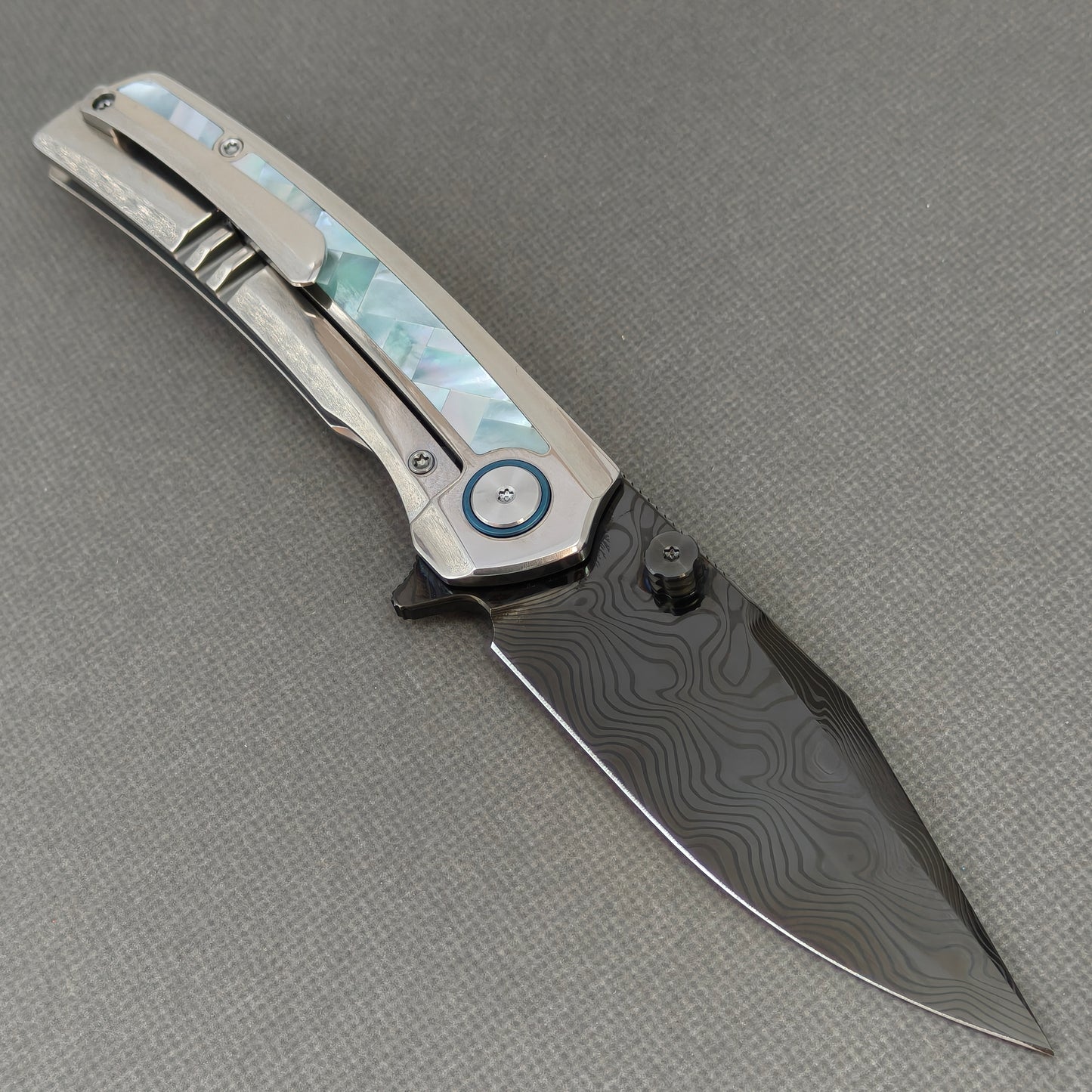 VORIXN KB104 Ocean Mirage Folding Knife – open clip side view showing pocket clip and Mother-of-Pearl Inlaid Titanium handle
