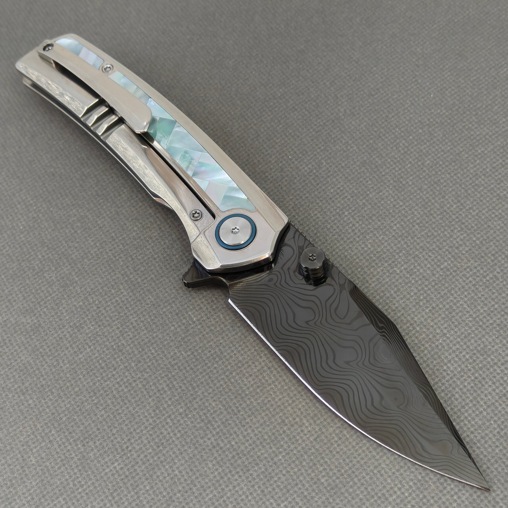 VORIXN KB104 Ocean Mirage Folding Knife – open clip side view showing pocket clip and Mother-of-Pearl Inlaid Titanium handle
