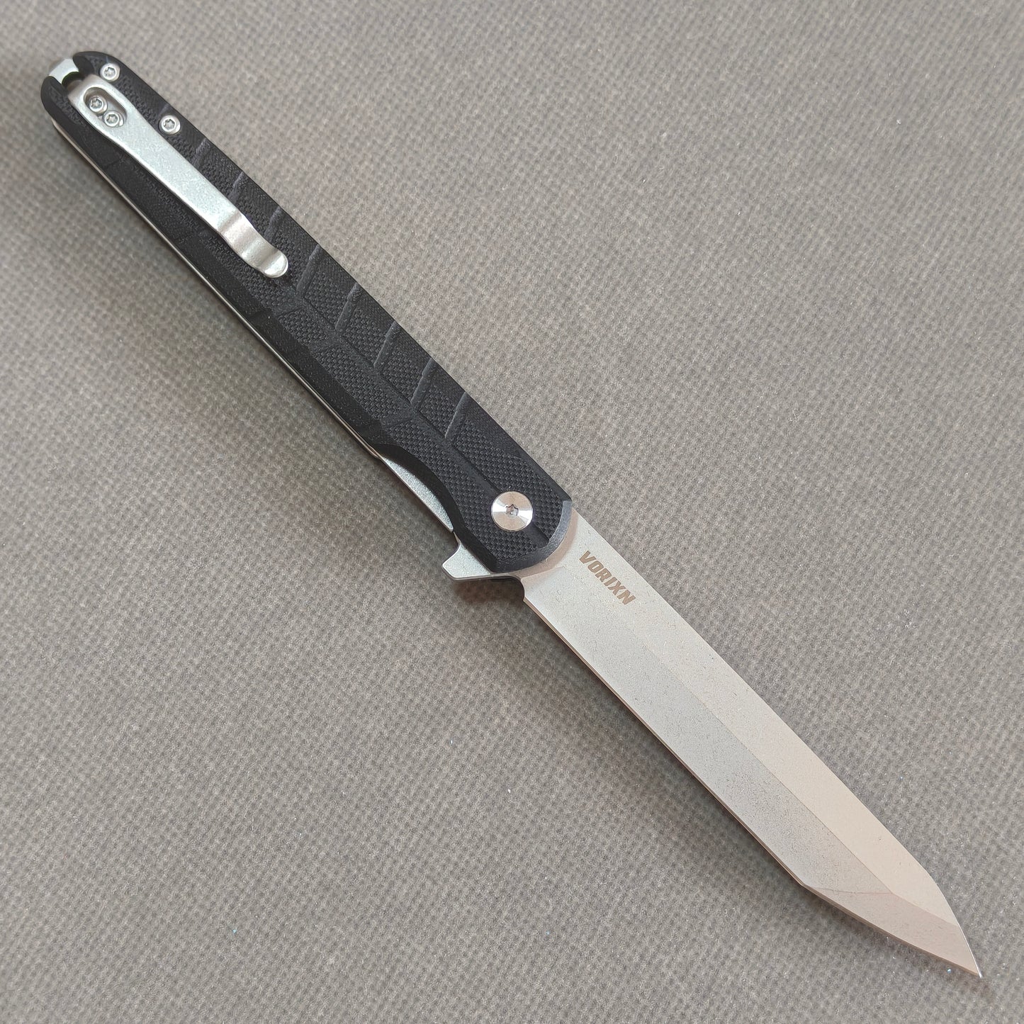 VORIXN KM001 open clip side view showing pocket clip and carbon fiber handle.