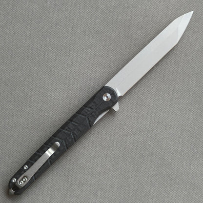 VORIXN KM001 open clip-side view showing pocket clip, carbon fiber handle structure, and overall profile.