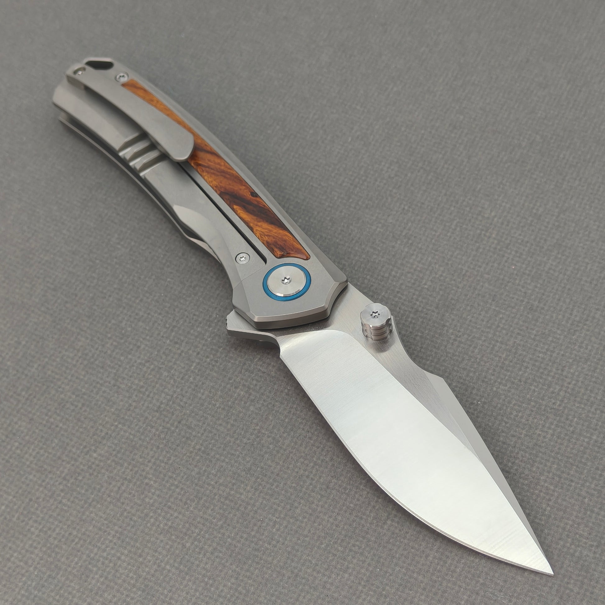 VORIXN KB040 open clip-side view showing pocket clip, titanium and ironwood handle, and overall profile.