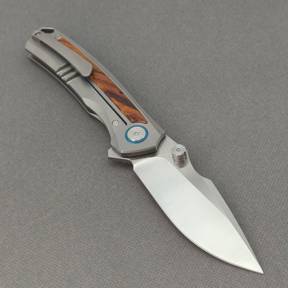 VORIXN KB040 open clip-side view showing pocket clip, titanium and ironwood handle, and overall profile.