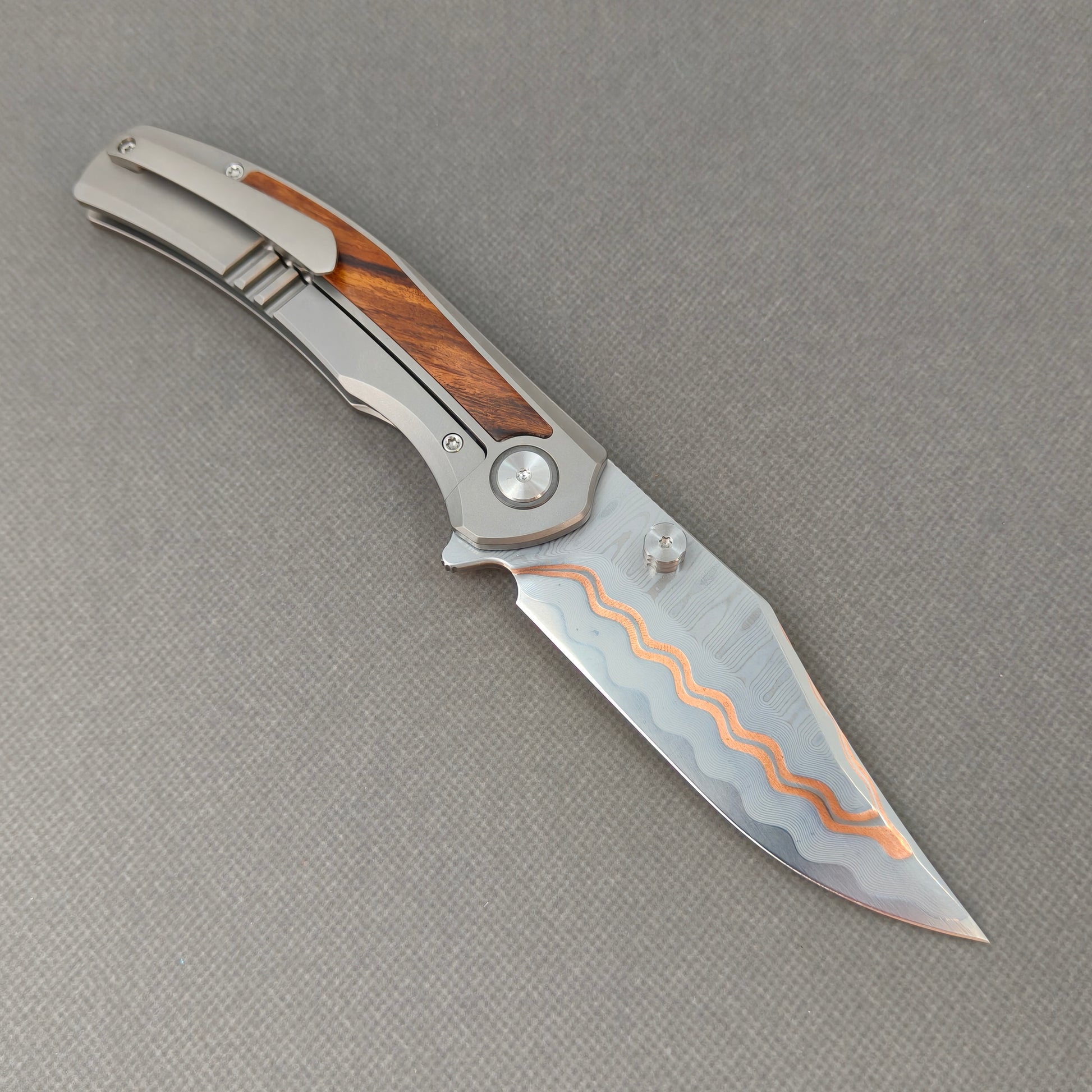 VORIXN KB074 open clip-side view showing pocket clip, titanium and desert ironwood handle, and overall profile.