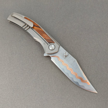 VORIXN KB074 open clip-side view showing pocket clip, titanium and desert ironwood handle, and overall profile.