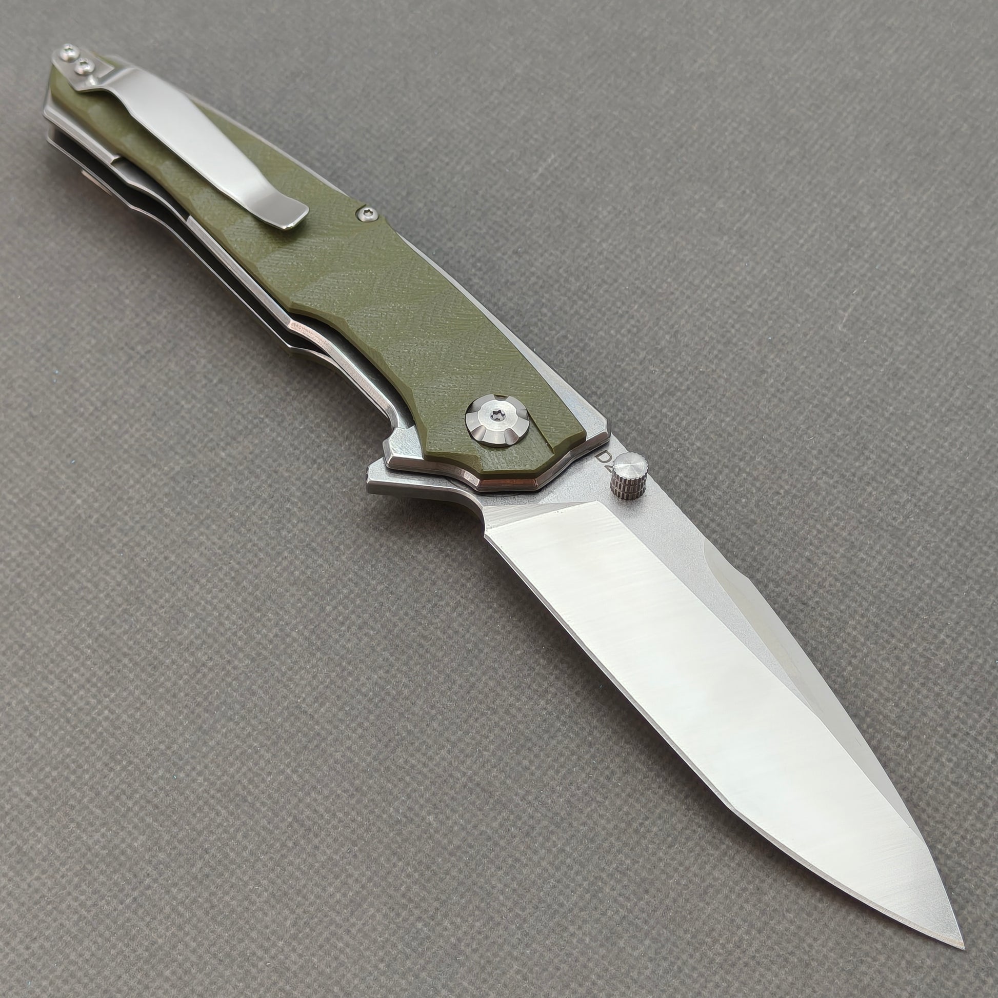 VORIXN KA007 open clip-side view showing pocket clip, forest green G10 handle, and overall profile.