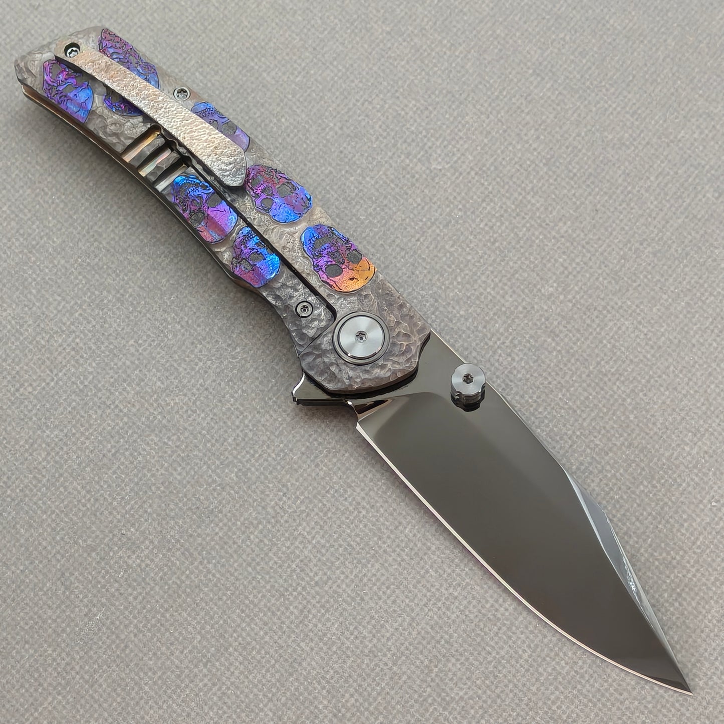 VORIXN Skull Nocturne KB120 Folding Knife – open clip side view showing pocket clip and hand-engraved anodized titanium handle
