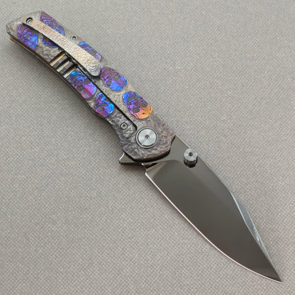 VORIXN Skull Nocturne KB120 Folding Knife – open clip side view showing pocket clip and hand-engraved anodized titanium handle