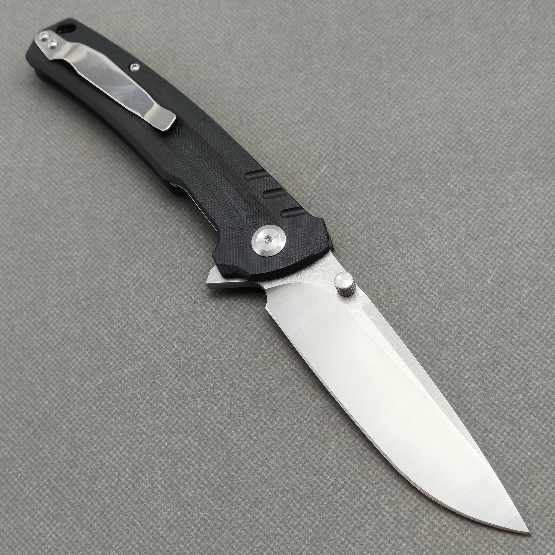 VORIXN KA001 open clip-side view showing pocket clip, black G10 handle structure, and overall profile.