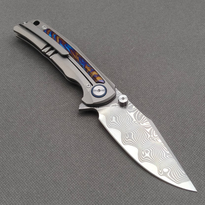 VORIXN KB019 open clip-side view showing pocket clip, hand-flamed zirconium inlay titanium handle, and overall profile.