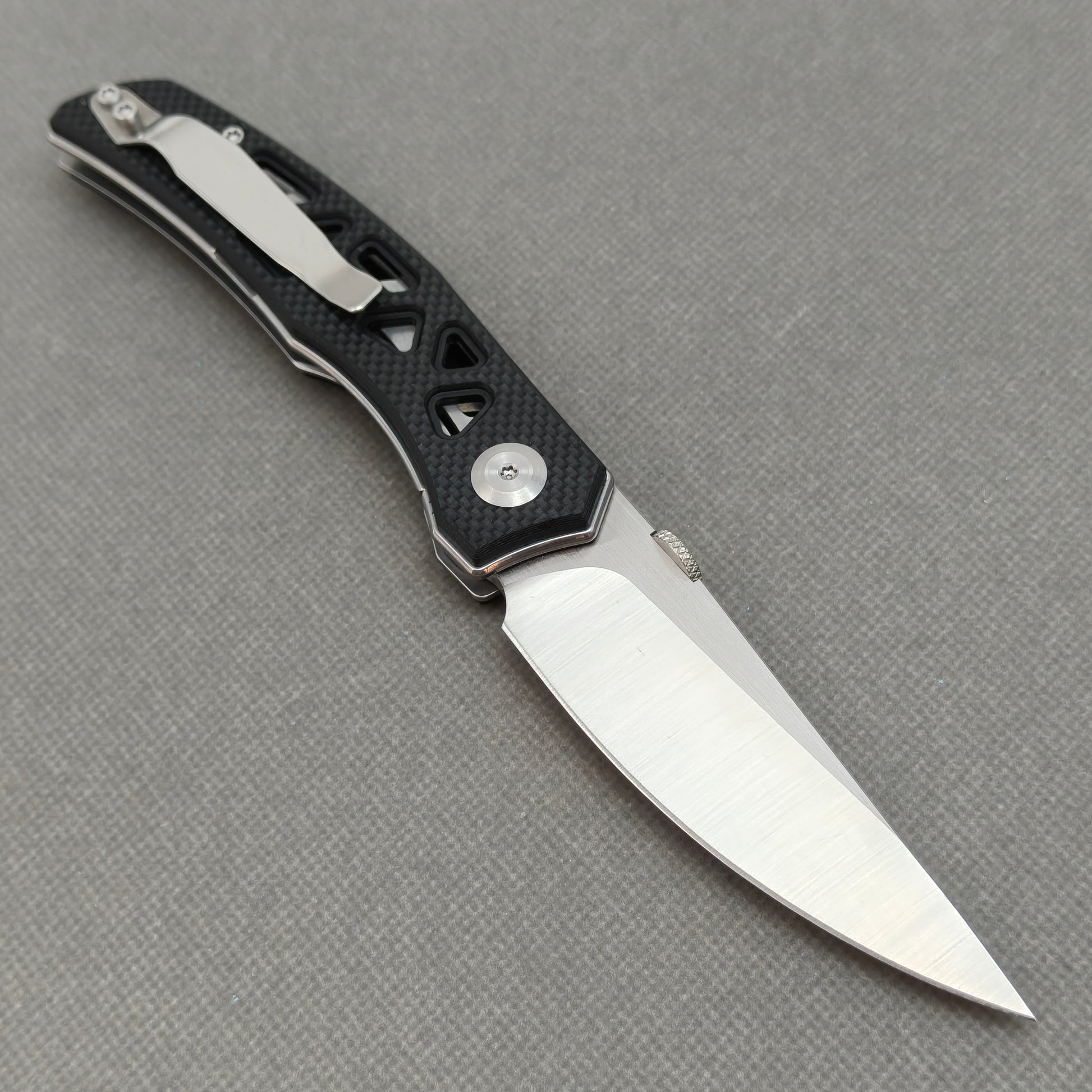 VORIXN KA003 open clip-side view showing pocket clip, black G10 handle structure, and overall profile.
