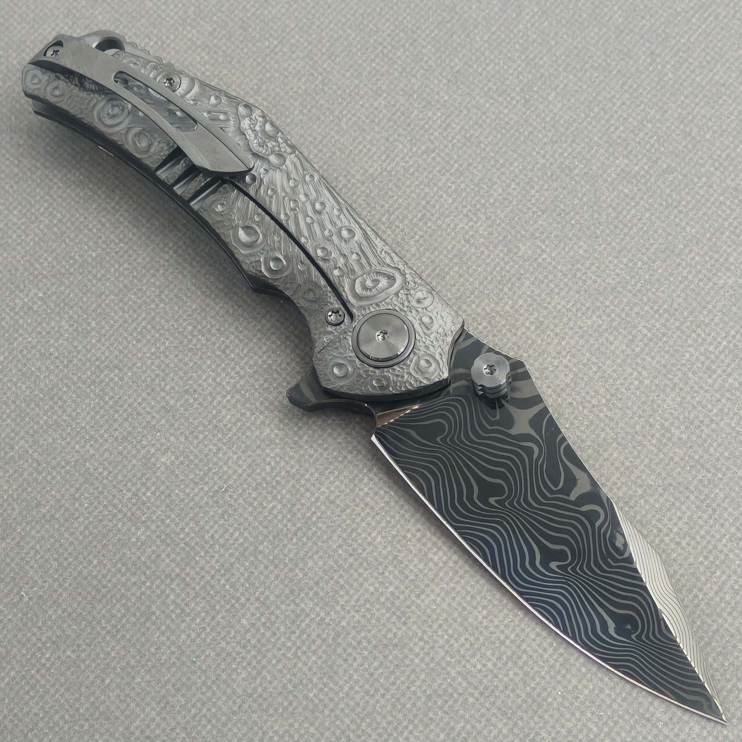 VORIXN Prism KB129 Folding Knife – open clip side view showing pocket clip and hand-engraved anodized titanium handle