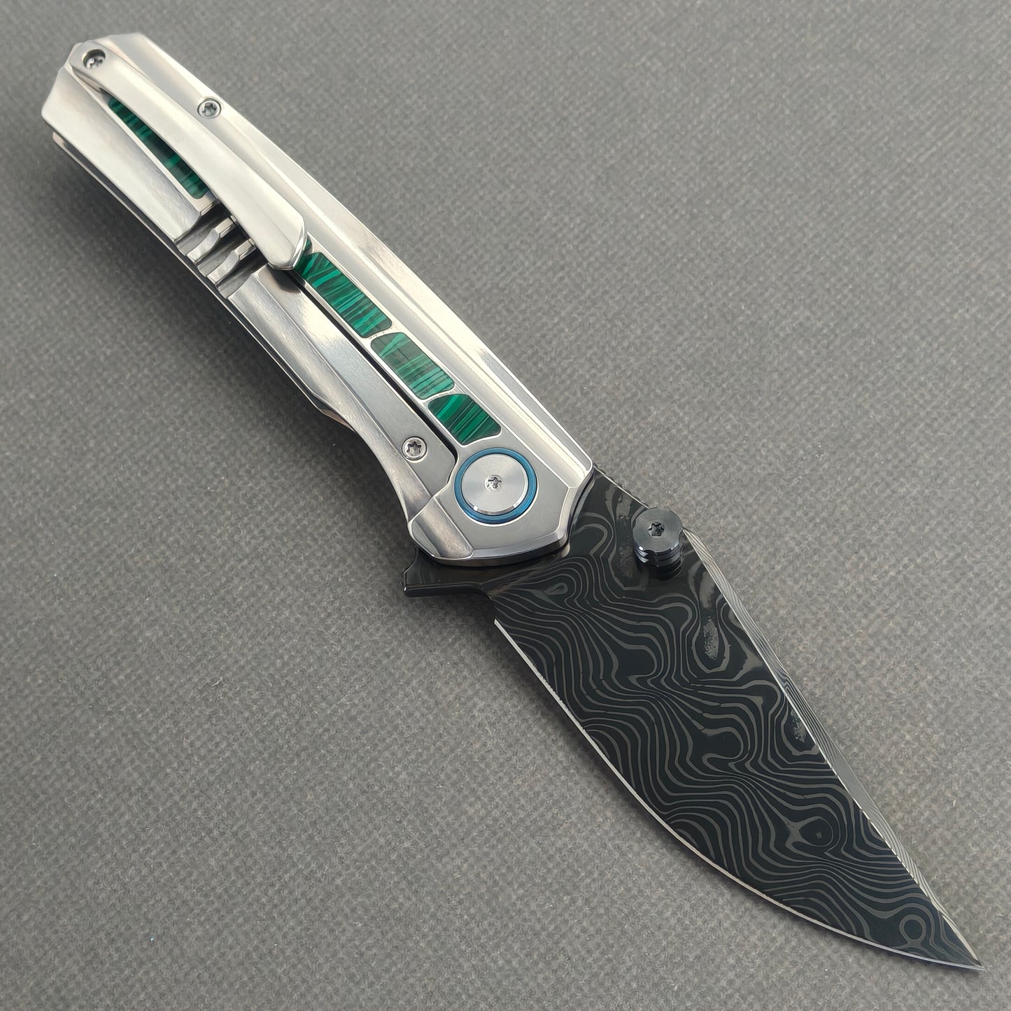 VORIXN Forest Mirage KB131 Folding Knife – open clip side view showing pocket clip and malachite inlaid titanium handle