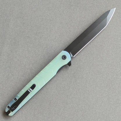VORIXN KM004 open clip-side view showing pocket clip, carbon fiber handle structure, and overall profile.
