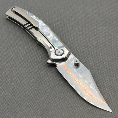 VORIXN KB068 open clip-side view showing pocket clip, white mother-of-pearl inlaid titanium handle, and overall profile.