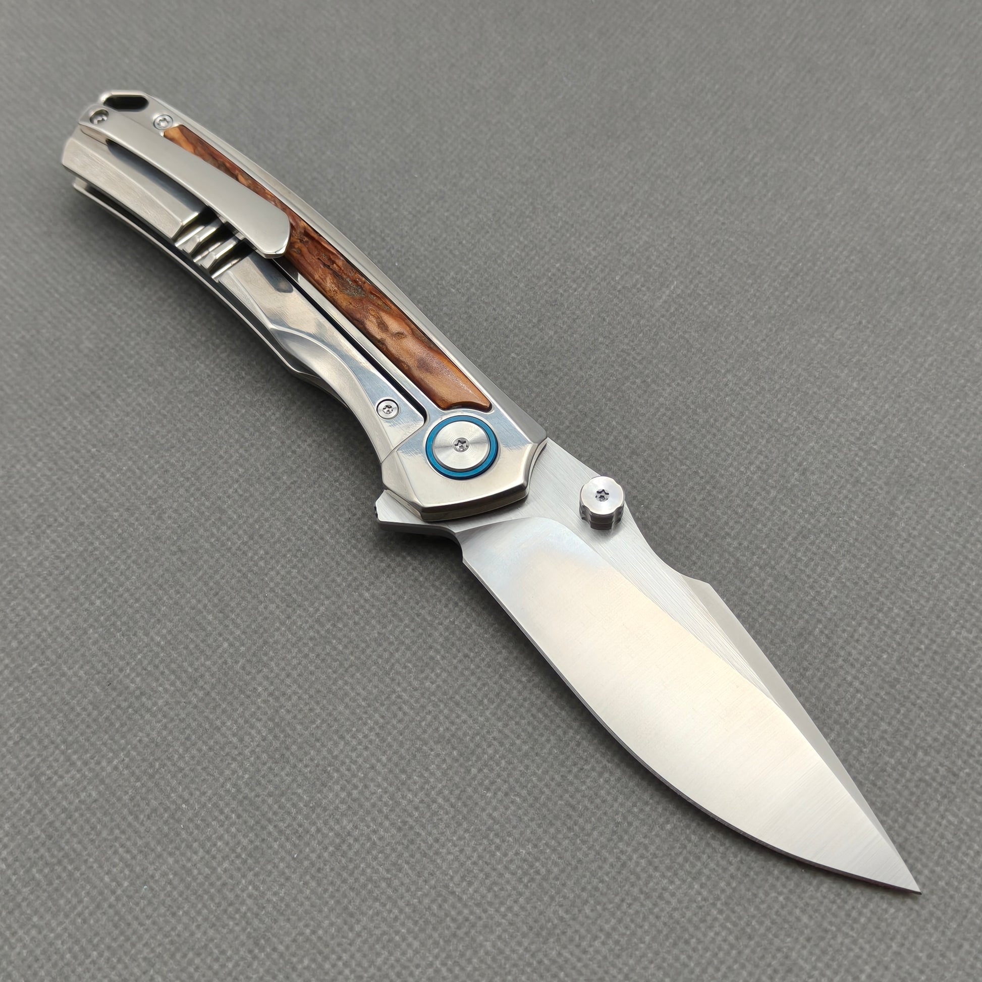 VORIXN KB043 open clip-side view showing pocket clip, titanium and natural stag inlay handle, and overall profile.