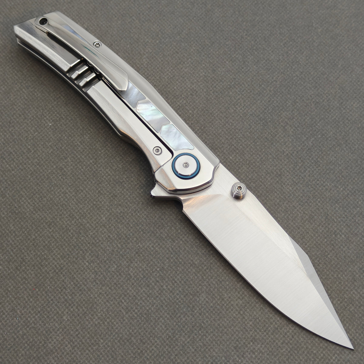 VORIXN Pearlglint KB159 folding knife, open pocket clip side showing white geometric inlays and a silver-tone blade.
