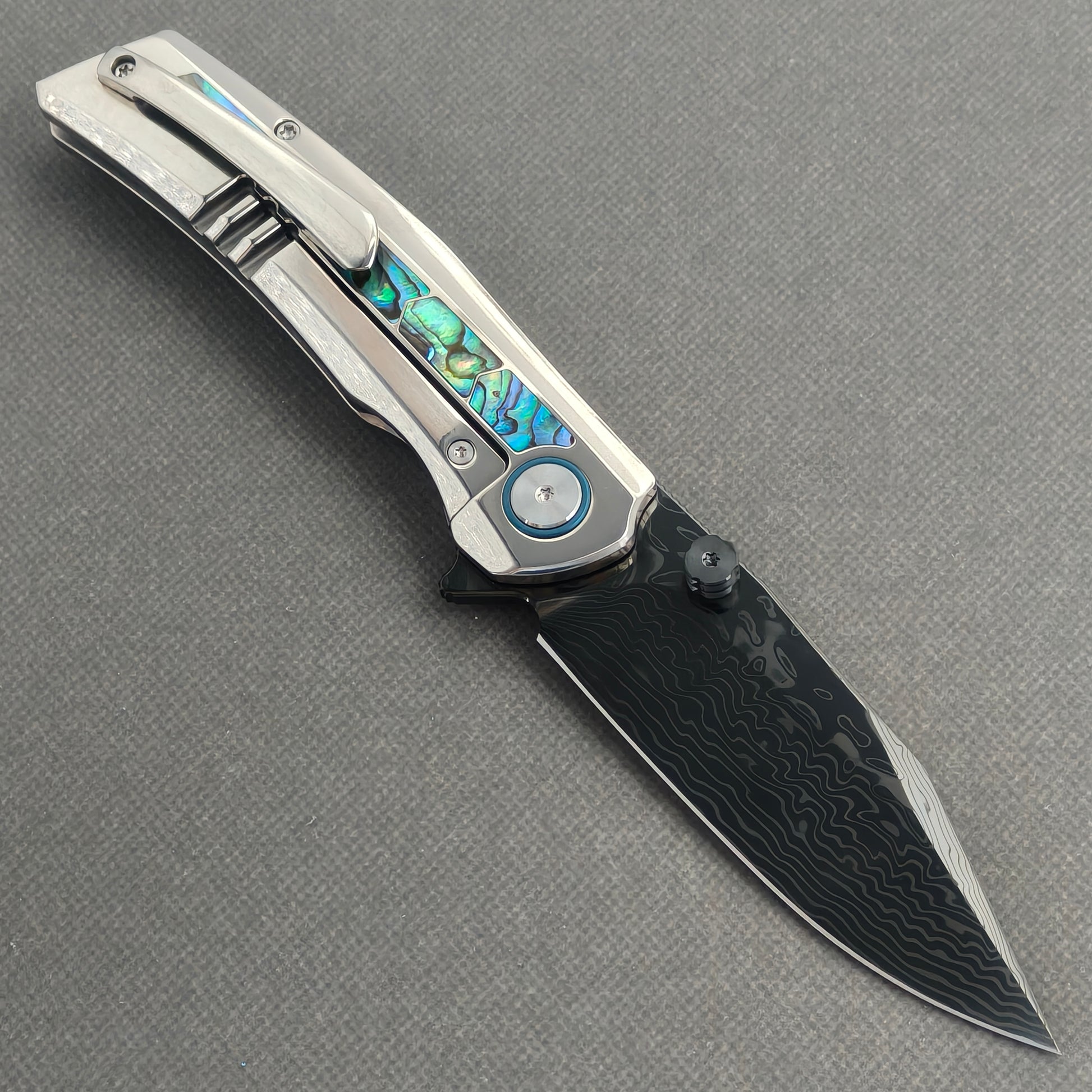 VORIXN Ocean Mirage KB130 Folding Knife – open clip side view showing pocket clip and abalone shell inlay titanium handle