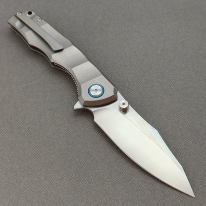 VORIXN KB014 open clip-side view showing pocket clip, metallic gray titanium handle, and overall profile.