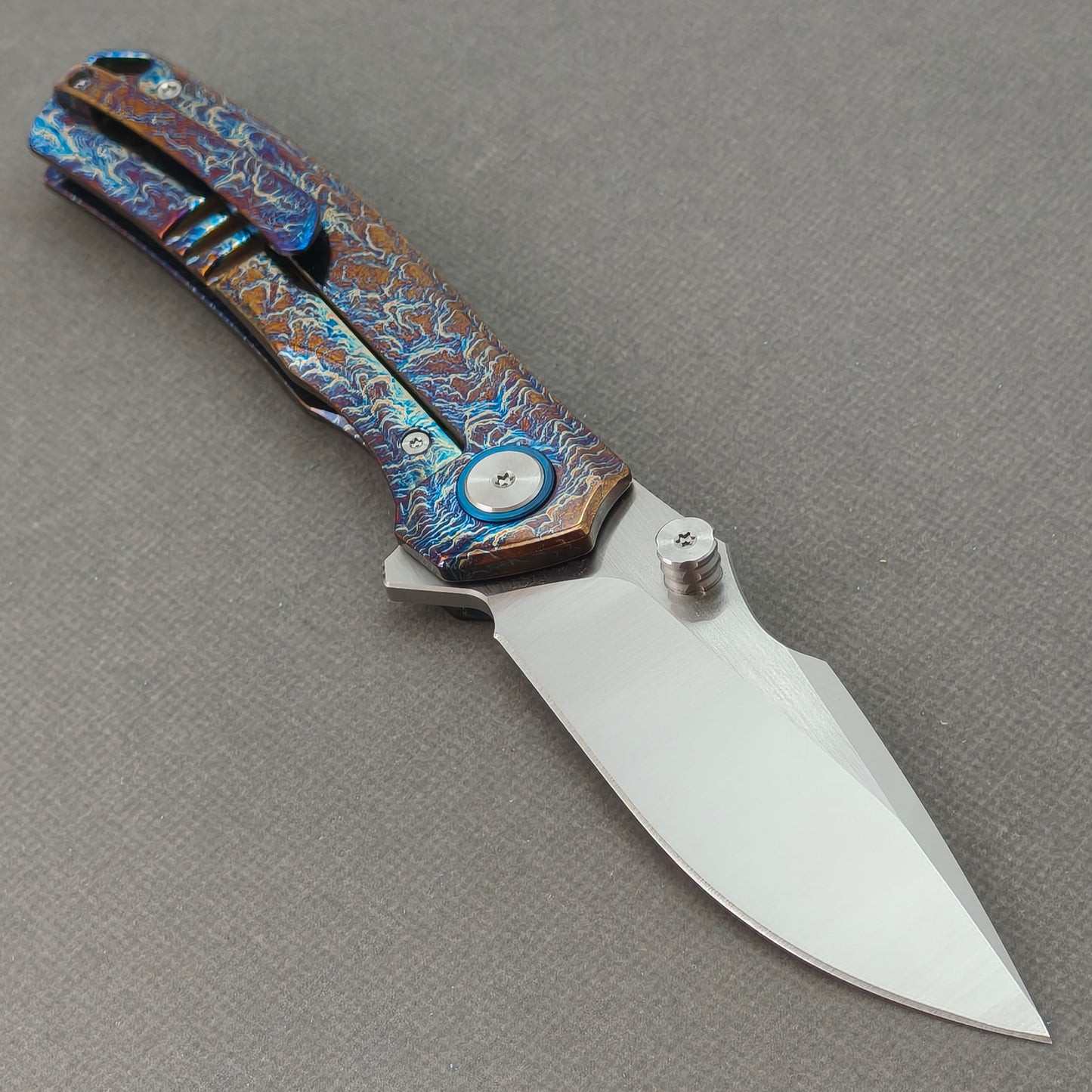VORIXN KB051 open clip-side view showing pocket clip, hand-flamed titanium handle, and overall profile.