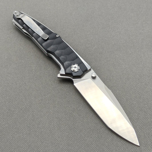 VORIXN KA009 open clip-side view showing pocket clip, black G10 handle, and overall profile.