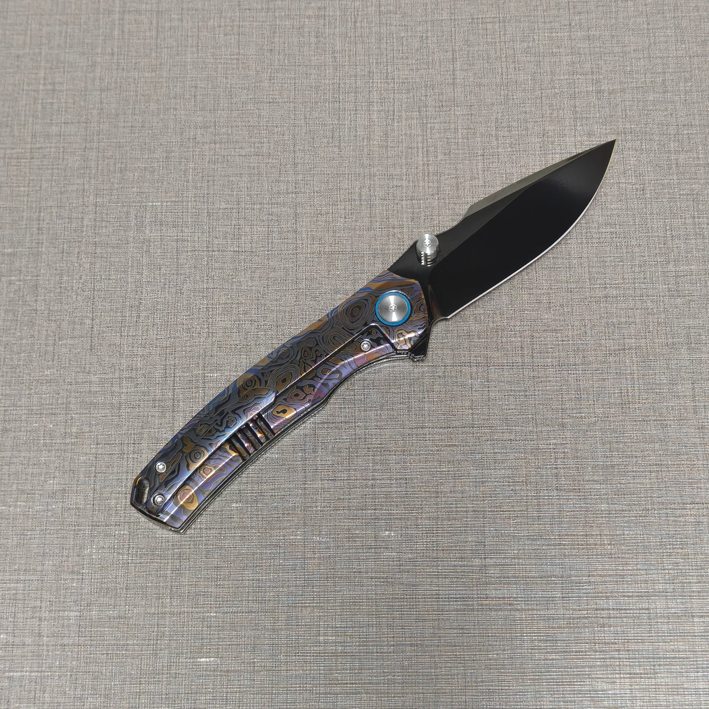 VORIXN Topograph folding knife open with pocket clip side visible, blade angled upward at 45 degrees
