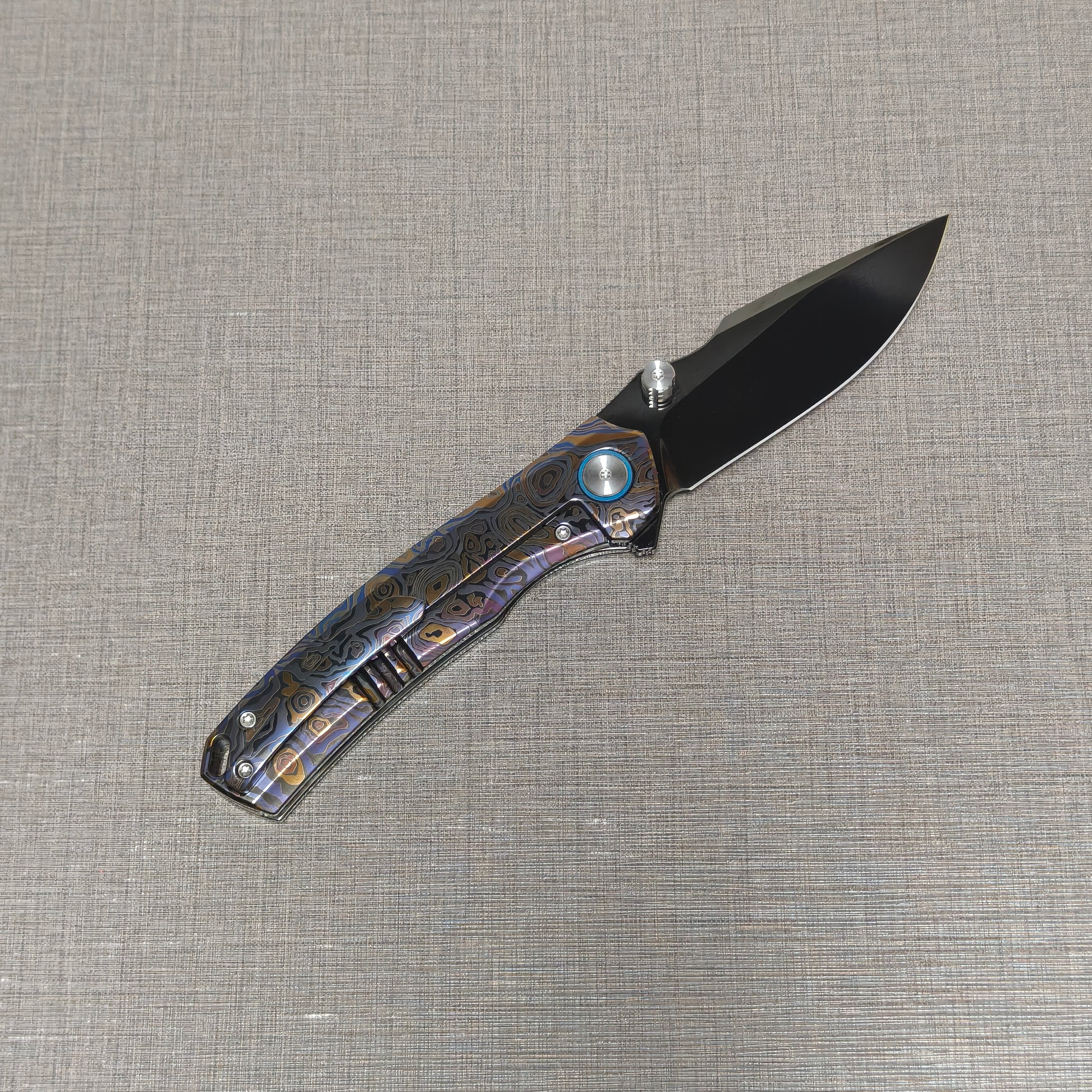VORIXN Topograph folding knife open with pocket clip side visible, blade angled upward at 45 degrees