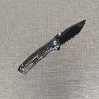 VORIXN Topograph folding knife open with pocket clip side visible, blade angled upward at 45 degrees