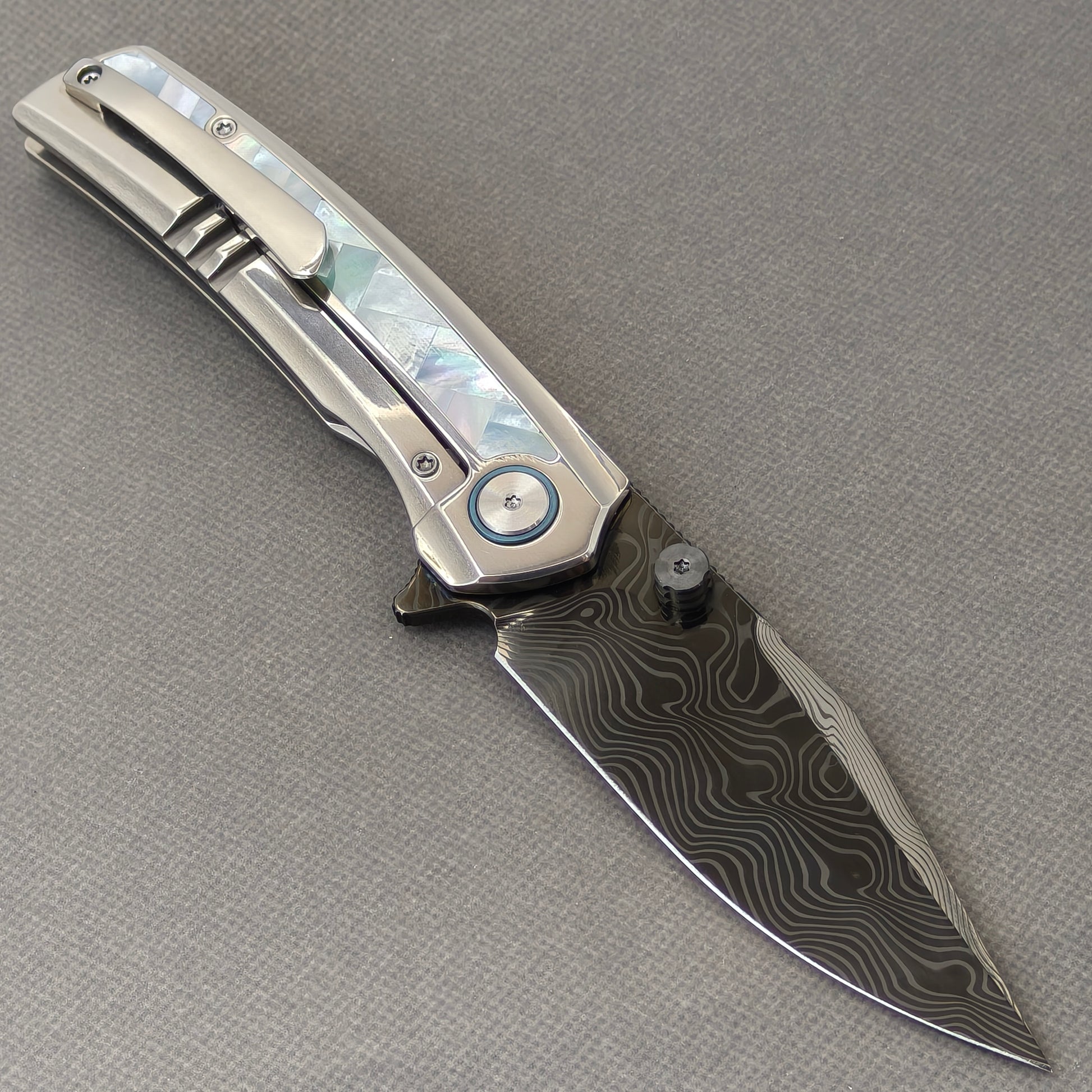 VORIXN Ocean Mirage KB104 Folding Knife – open clip side view showing pocket clip and White Mother-of-Pearl Inlaid Titanium handle