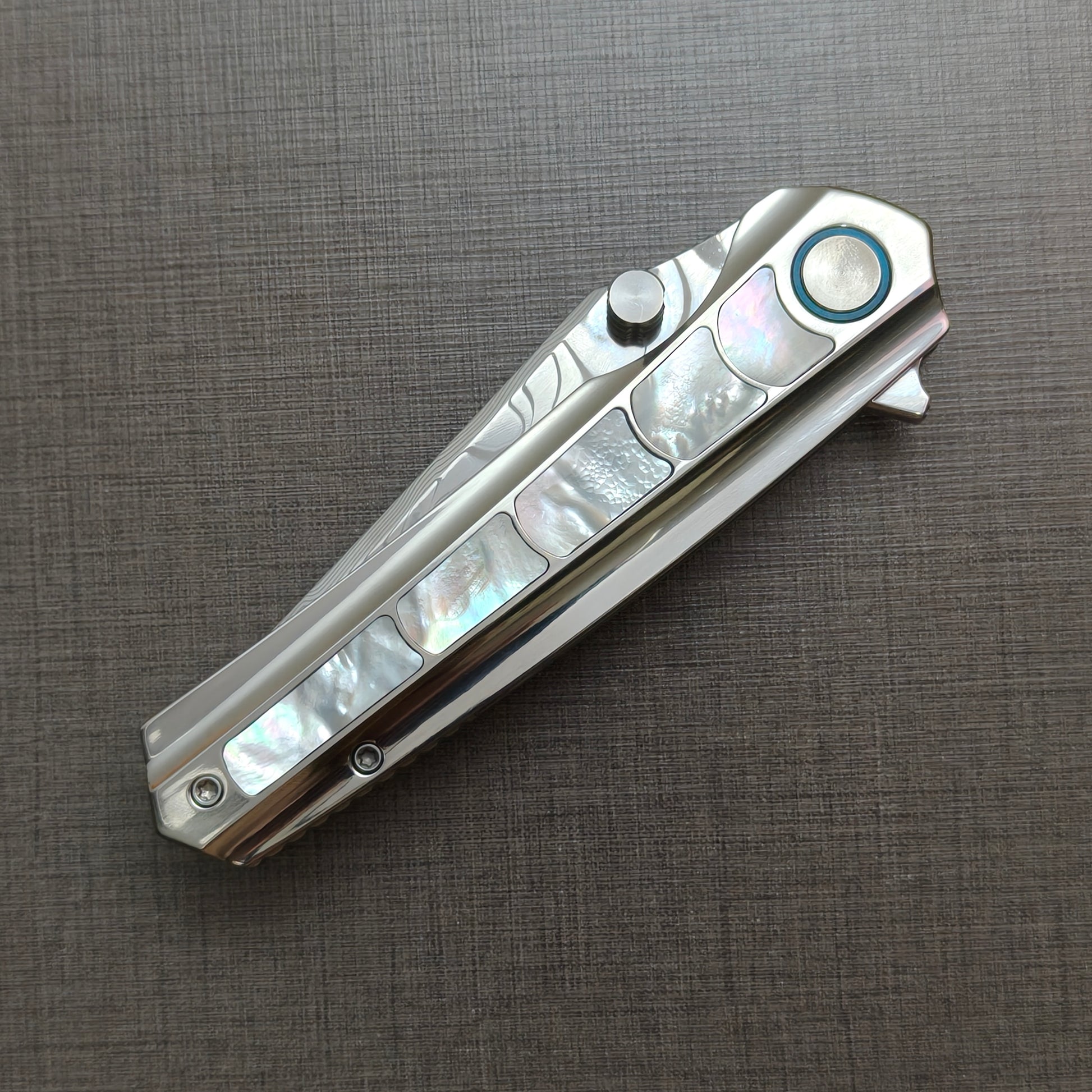 VORIXN Ocean Mirage folding knife closed, non-clip side, showcasing mother-of-pearl handle artwork and overall profile