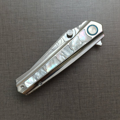 VORIXN Ocean Mirage folding knife closed, non-clip side, showcasing mother-of-pearl handle artwork and overall profile