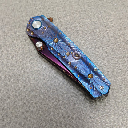 VORIXN Impact Origin folding knife closed, non-clip side showing full engraved titanium handle inspired by meteor impacts