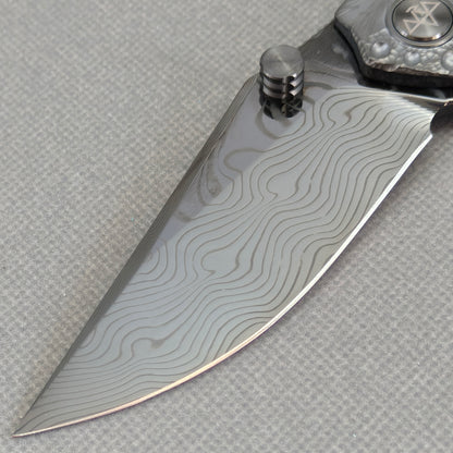 VORIXN KB098 Impact Origin Folding Knife – clip side blade detail showing Damascus steel and handle junction