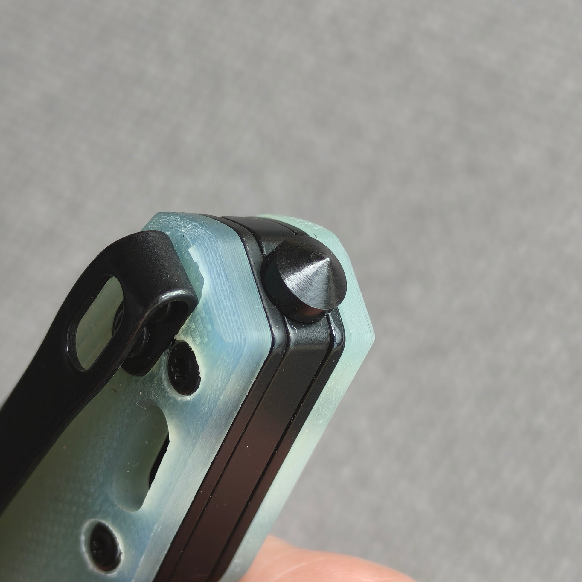 VORIXN KM005 closed rear handle end detail showing metal tail tip and handle construction.