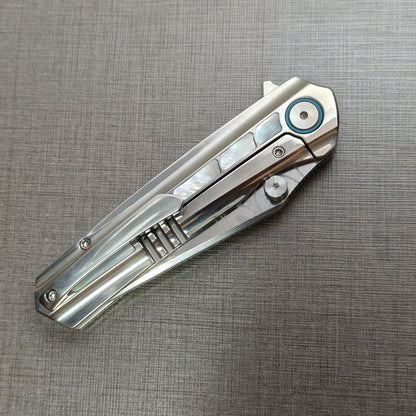 VORIXN Ocean Mirage folding knife closed, pocket clip side, full view of titanium handle and clip design